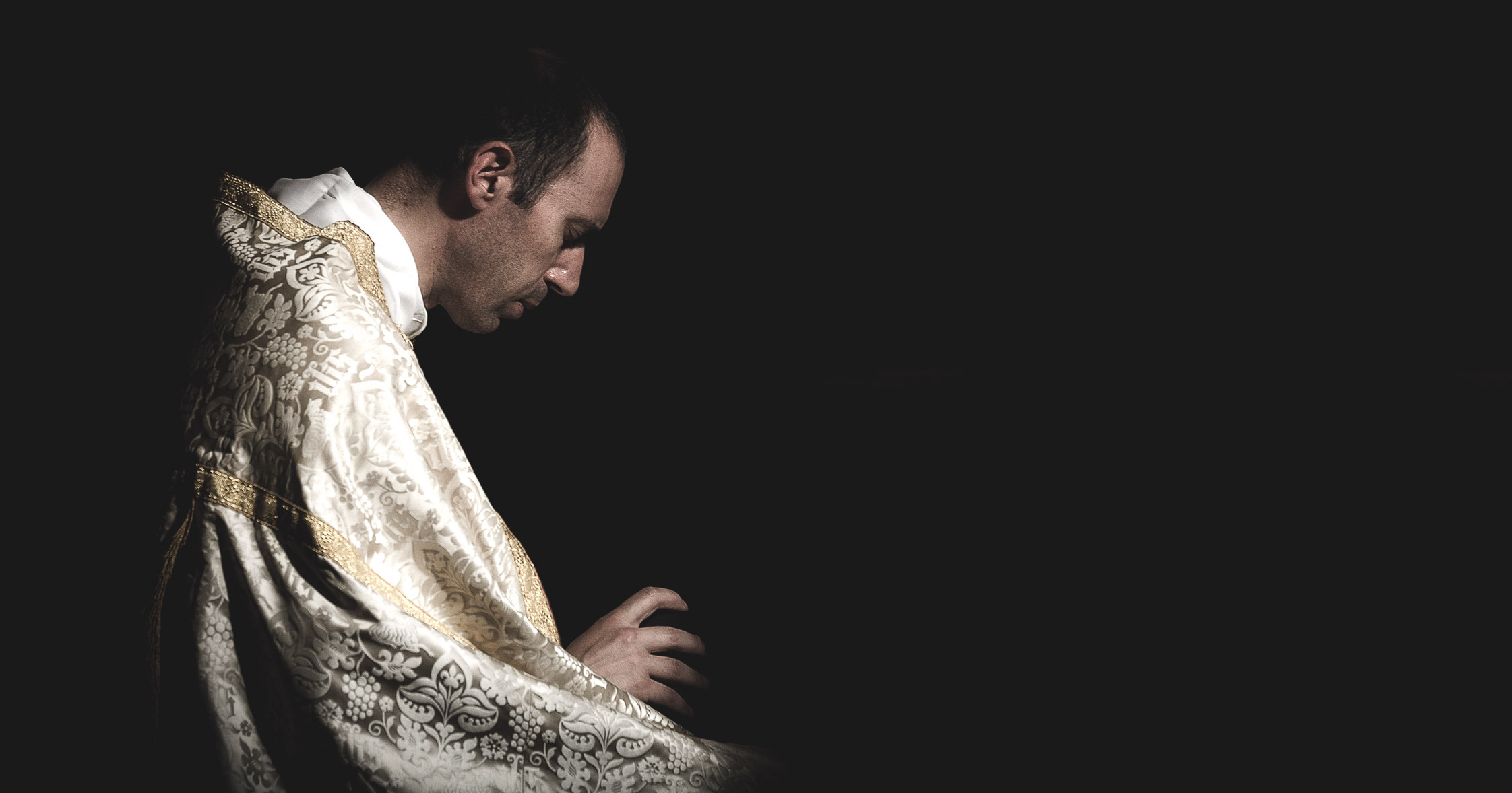 Priest belonging to Priestly Fraternity of Saint Peter, praying before Mass